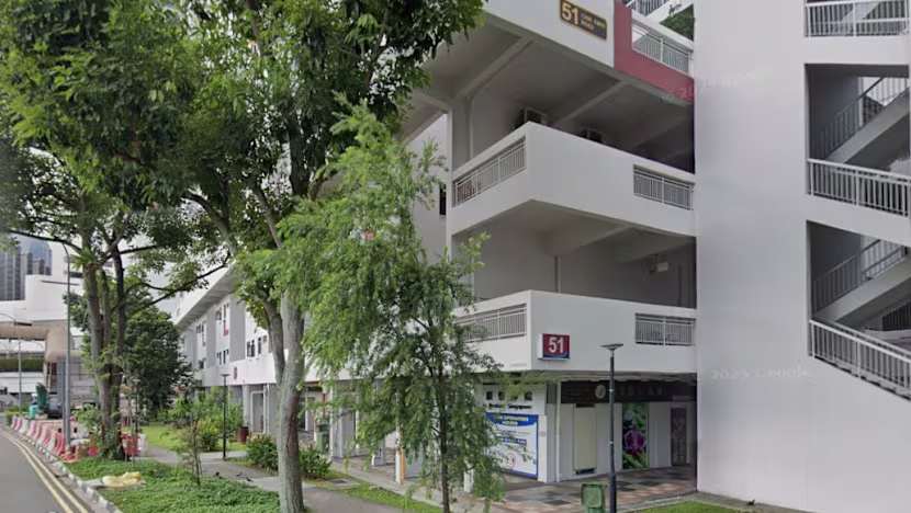 View from the pavement looking across Chin Swee Road toward the HDB block