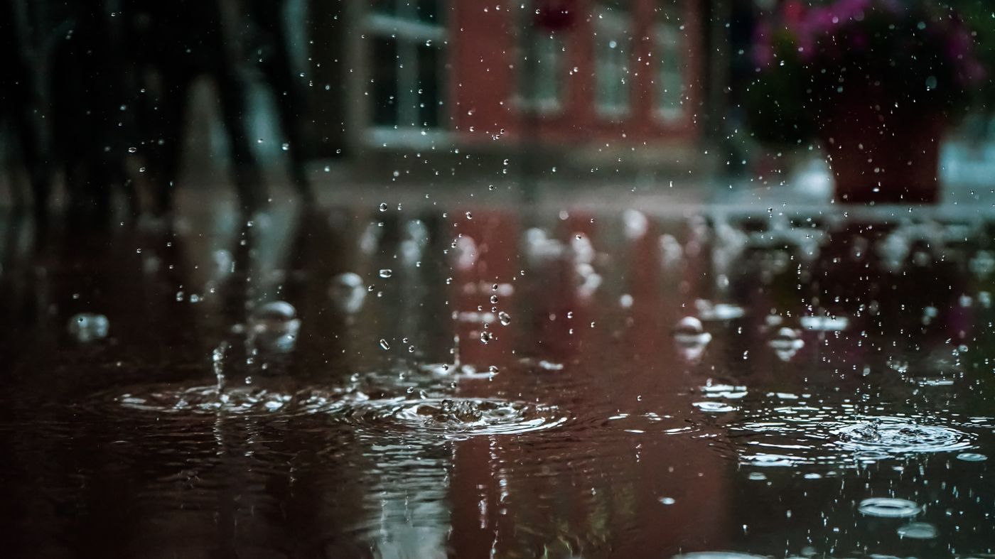 Rain streaking down a window pane from inside